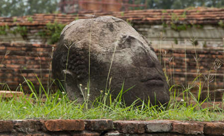 Old head of buddha statue at Ayuttaya, Thailandの写真素材