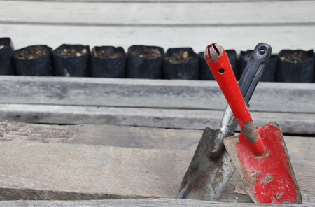 Rust spades with soil on wooden floorの写真素材