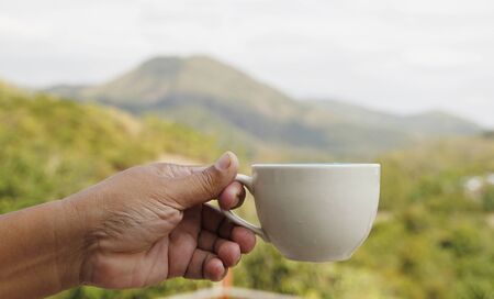 Coffee cup with mountain backgroundの写真素材