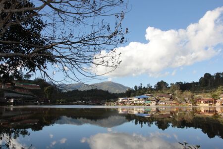 Reflect of hill and house in the riverの写真素材