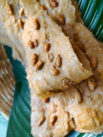 A minimalist still life of elongated banana sticks, air-dried to a soft chew and topped with sunflower seeds.の写真素材