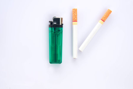 Cigarette and lighter on white backgroundの写真素材