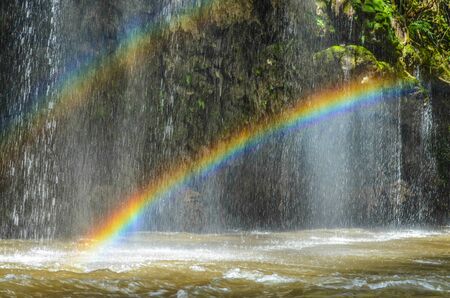 Tropical waterfall with rainbowの写真素材