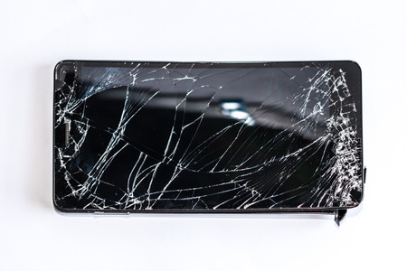 Mobile phone with broken screenの写真素材