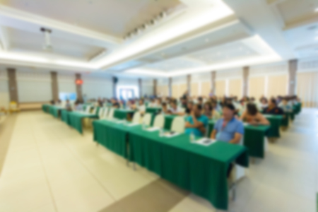 Front view of many listeners sitting on chairs during lecture at conferenceの写真素材