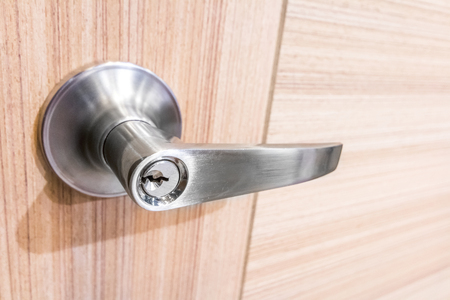 Modern style door handle on natural wooden doorの写真素材