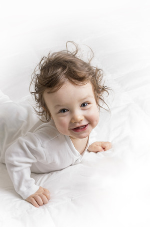 Baby girl looking at the camera and smilingの写真素材