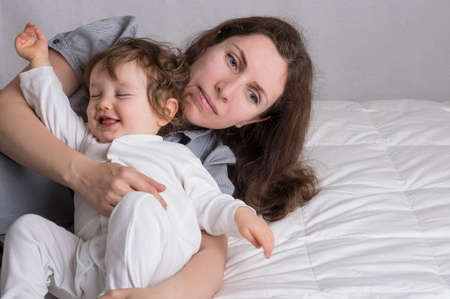 Baby girl playing with motjer and have fun. Copy space on right.の写真素材