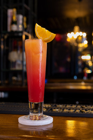Sex on the beach ombre effect alcoholic cocktail garnished with orange