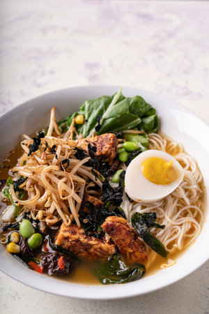 Asian fusion vegan meat-free ramen noodles with mushrooms, fermented tofu, sprout, beans, vegan egg...