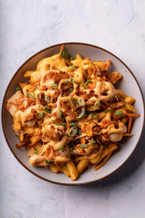 Loaded dirty vegan fries with pickled cabbage, hot mayo and crunchy coconut flakes