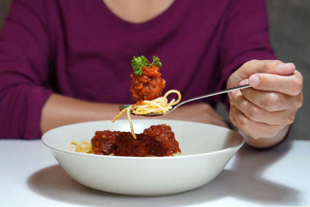 front view spicy pork spaghetti on a spoon, italian foodの写真素材