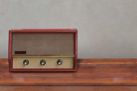 front view Ancient red turntables on wooden floor, grey wall background, object, ancient, copy spaceの写真素材