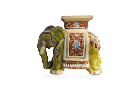 side view antique green and cream elephant ceramic standing on white background, vintage, object, animal, decor, copy spaceの写真素材