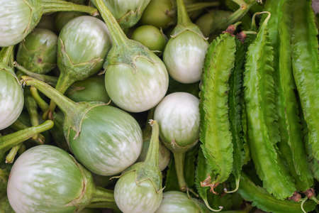 top view half fresh solanum melongena vegetables and winged bea vegetables background, vegetable,...