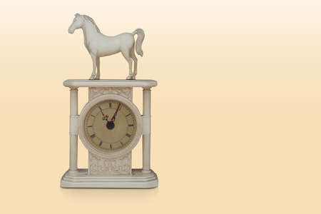 antique white ceramic watch, horse shape on the watch on yellow background, object, decor, vintage,...