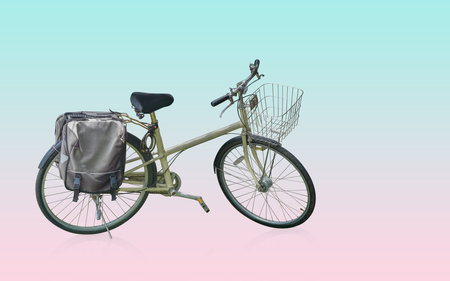 yellow and black body of bicycle with old and silver front basket, black handles and seat which is two tone color, on green and pink background, object, bike, speed, copy spaceの写真素材