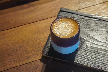 top view coffee in red and brown ceramic cup on wooden plate, wooden floor background, decor,...