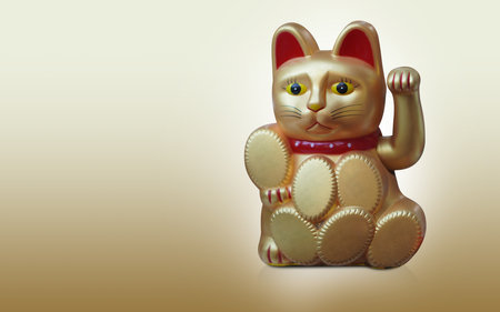 front view gold lucky cat sitting and holding on gold background, object, religion, animal, decor, gift, copy spaceの写真素材