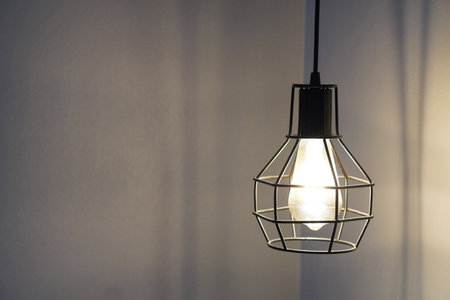 black steel Iron lights hang down on a white wall background, object, light, decor, modern, copy...