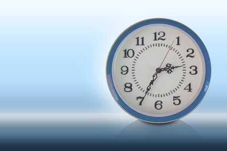 front view white and blue plastic wall clock, on gradient white and blue background, object, decor,...