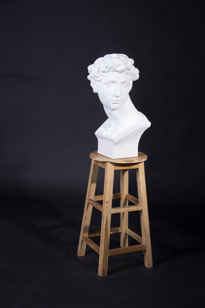 The statue was placed on a chair man curly hair のeditorial素材