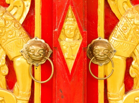 Traditional Thai art by wood carvings on a window in a temple  Wat Kham Thale So ,NAKORNRATCHASIMA,THAILANDの写真素材