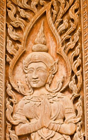 The old traditional Thai art wood carvings on a door in a temple  Wat Liab ,NAKORNRATCHASIMA,THAILAND の写真素材