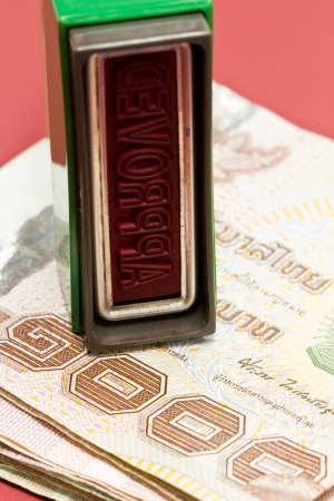 APPROVED word of Rubber stamp on thai Money  の写真素材