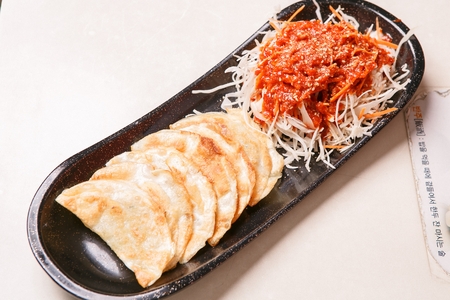 Fried Dumplings with Vegetables in Spicy Sauceの写真素材