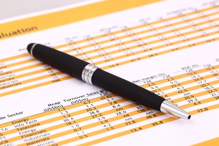 Data analyzing in stock market on the quotes prints, and a penの写真素材