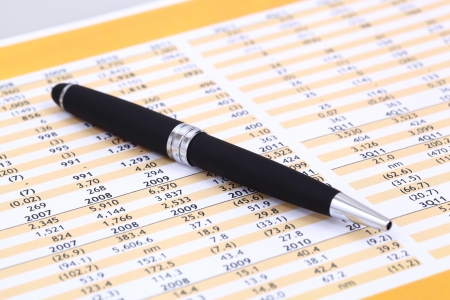 Data analyzing in stock market on the quotes prints, and a penの写真素材