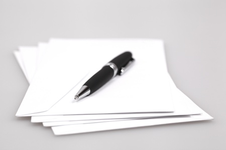 envelopes and ball pen on a gray tableの写真素材