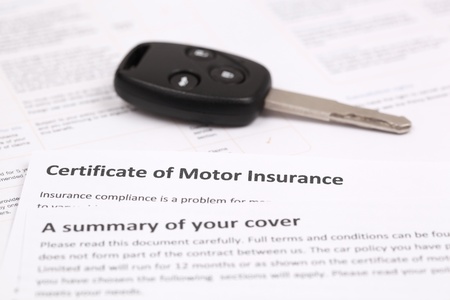Certificate of motor insurance with car keyの写真素材