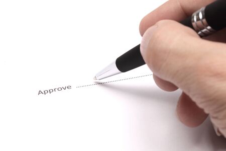 Close up of businessman signing a approveの写真素材