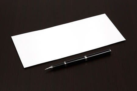 envelope on a table with penの写真素材