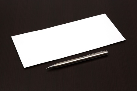 envelope on a table with penの写真素材