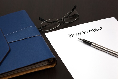 Organizer on table with word new project close up in paperの写真素材