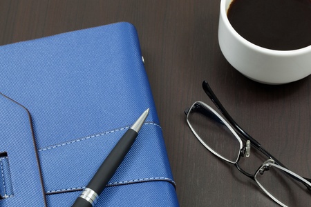 Organizer on table with pen and glassesのeditorial素材