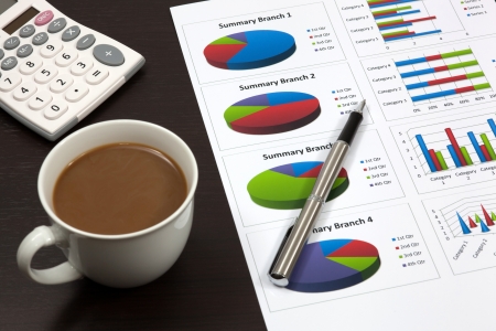 Business report. Cup of coffee on document.の写真素材