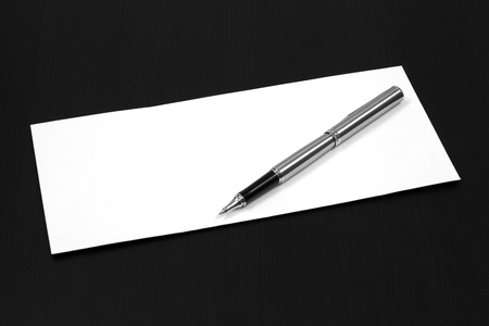 envelope on a table with penの写真素材