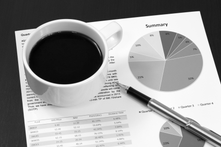 Business report  Cup of coffee on document の写真素材