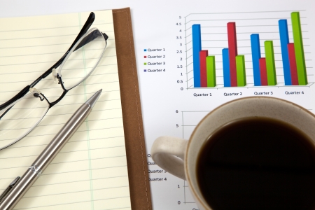 Business report with cup of coffeeの写真素材