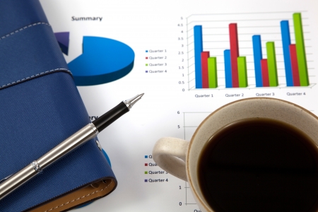 Business report with cup of coffeeの写真素材