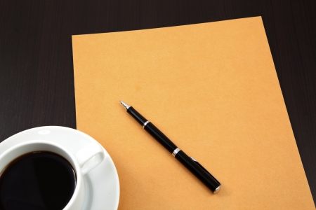 folder with coffee cup on tableの写真素材