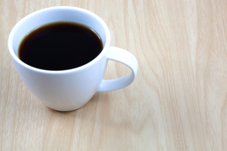 Cup of coffee on a wooden tableの写真素材