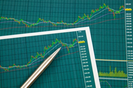 A pen on the Stock chart and financial reportの写真素材