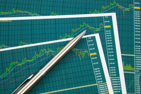 A pen on the Stock chart and financial reportの写真素材