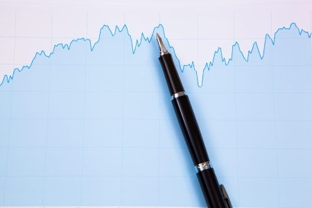 A pen on the Stock chart and financial reportの写真素材