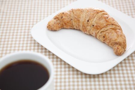 Croissant and a cup of coffeeの写真素材